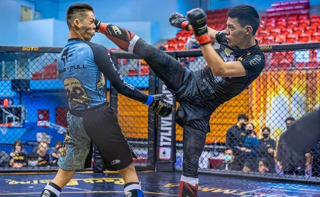 A fighter lands a high kick during a striking match
